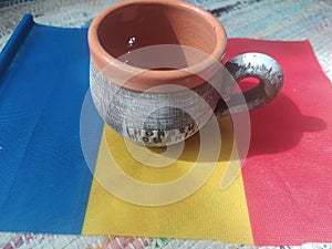 Handmade traditional Romanian objects placed on the Romanian flag and on a handmade carpet during the loom