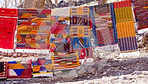 Handmade traditional in vibrant colors berber rugs hanged on lin