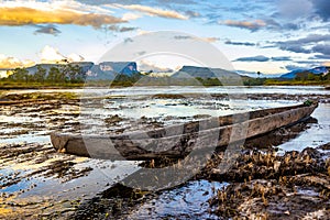 Handmade tribal wooden boat on Carrao river in Canaima national park at sunset