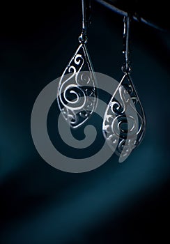 Handmade Vintage Silver earrings on dark background.