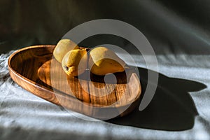 Handmade walnut round wooden pallet, wooden chopping board Empty pear gray background bowl with wood rings Handmade plank texture