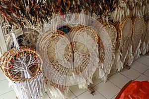 Handmade white dream catcher with wooden and rattan ring. Souvenirs in a tourist shop