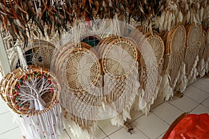 Handmade white dream catcher with wooden and rattan ring. Souvenirs in a tourist shop