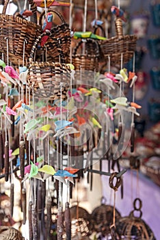 Handmade wind chimes on an outdoor market stall in a gift shop