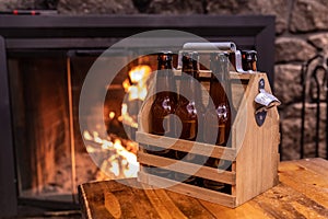 Handmade wooden carrying case for six beer bottles with a metal bottle opener on a side