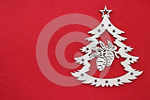 Handmade wooden Christmas tree on a red background