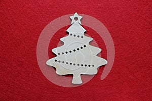 Handmade wooden Christmas tree on a red background