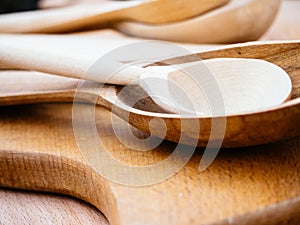 Handmade wooden kitchen utensils. Spoons and wooden planks for Housewives