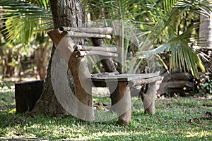 Handmade wooden log bench under the tree, perfect spot for sitting and relaxing