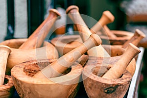 Handmade wooden mortar. Kitchen utensils. Wooden mortar composition background. Wood texture on kitchen utensils