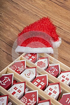 handmade wooden perpetual calendar in a form of a house with christmas hat