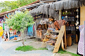 Handmade wooden pieces being sold at craft fair in Bahia in Brazil. Spoons, bundles, purses, musical instruments.