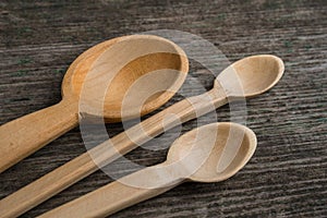 Handmade wooden spoons on a wooden board, kitchen tools