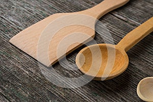 Handmade wooden spoons on a wooden board, kitchen tools