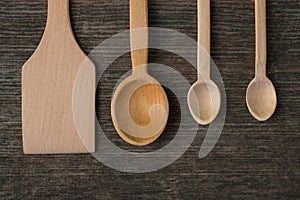 Handmade wooden spoons on a wooden board, kitchen tools