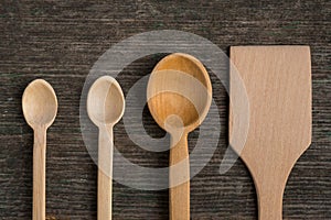 Handmade wooden spoons on a wooden board, kitchen tools