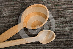 Handmade wooden spoons on a wooden board, kitchen tools