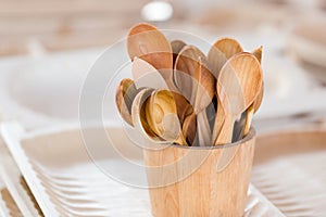 Handmade wooden tea spoons in wooden basket