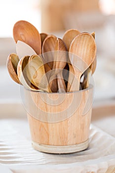 Handmade wooden tea spoons in wooden basket