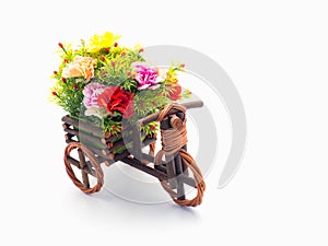 Handmade wooden tricycle toy with flower in the basket isolated
