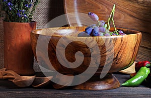 Handmade wooden utensils on the kitchen table. Wooden plates, bowls, dishes and spoons on the table