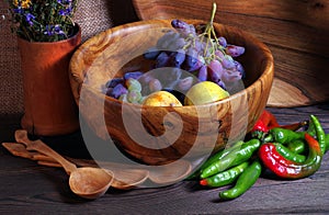 Handmade wooden utensils on the kitchen table. Wooden plates, bowls, dishes and spoons on the table