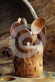 Handmade wooden utensils on the kitchen. Wooden spoons, bowl, dishes and vase