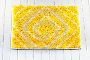 Handmade yellow and white wool mat