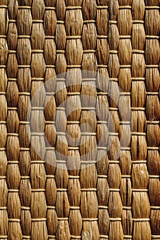 Handmade yelow wicker placemat made from water hyacinth, nature background