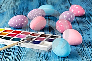 Handmaid blue paint easter egg on table with scarf