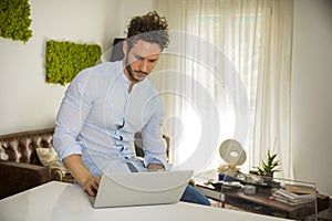 Handosme Man Working at Home at Computer Desk