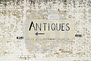 Handpainted antiques sign on track wall