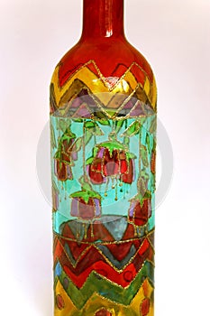 Colourful patterned hand painted glass bottle. photo