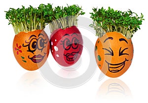 Handpainted Easter eggs with funny happy smiling faces with cress like hair look at other foreign individuals egg.