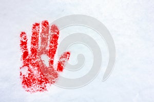 Handprint palm on the snow close up. Blood in the snow.