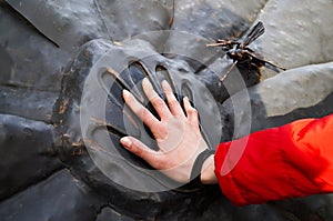 A handprint in the stone and a hand in it