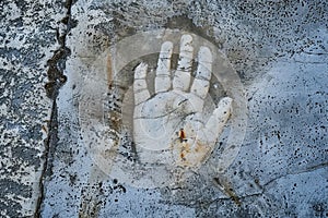 Handprint on textured concrete wall. Urban street art and vandalism concept for design and print