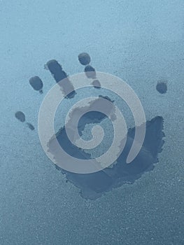 Handprint on the windscreen of the car