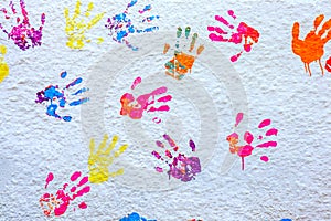 Handprints paint on a white wall