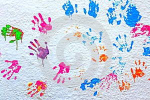 Handprints paint on a white wall