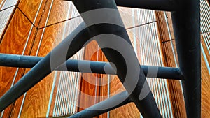 Handrail in black with a unique alternation against the background of the orange striped floor