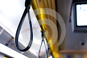 Handrail in the bus with hanging handgrips