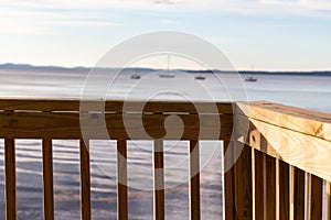 Handrail in the foreground with Penobscot bay and moored boats in the background