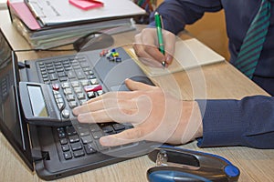 Hands of accountant with calculator and pen. Accounting background. Businessman using a calculator to calculate the numbers