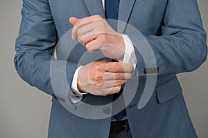 Hands adjusting sleeves formal suit business outfit, perfectionism concept