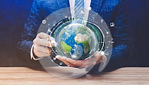 hands of a african american child holding crystal glowing globe planet earth at a sunny green meadow background copyspace taking