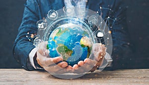 hands of a african american child holding crystal glowing globe planet earth at a sunny green meadow background copyspace taking