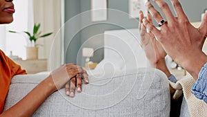 Hands of African couple talking, communication and conversation while sitting on the sofa. Black man and woman having a