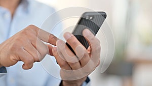 Hands of African Man using Smartphone, Close up