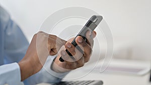 Hands of African Man Using Smartphone, Close Up